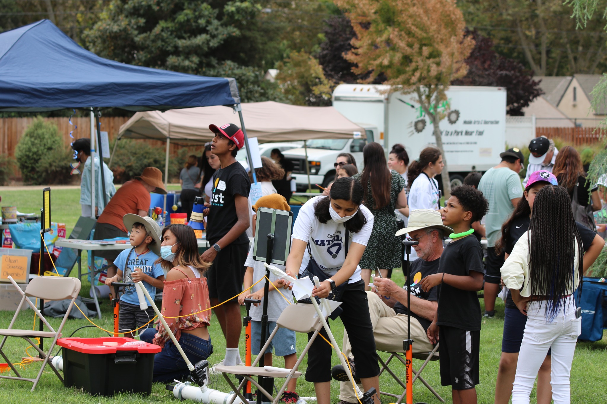 Families exploring hands-on activities at a community science event